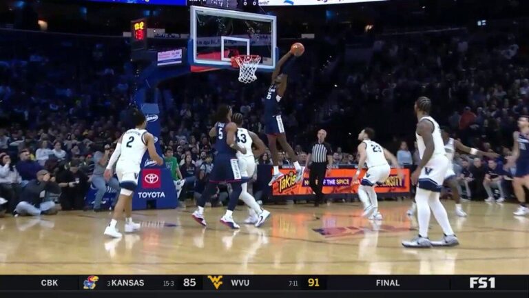 Samson Johnson throws down a strong two-handed alley-oop to extend UConn