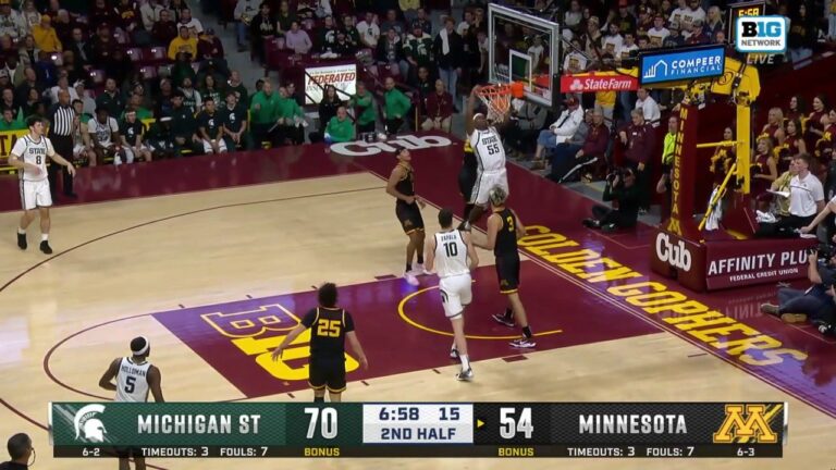 Coen Carr throws down a powerful two-handed slam, extending Michigan State